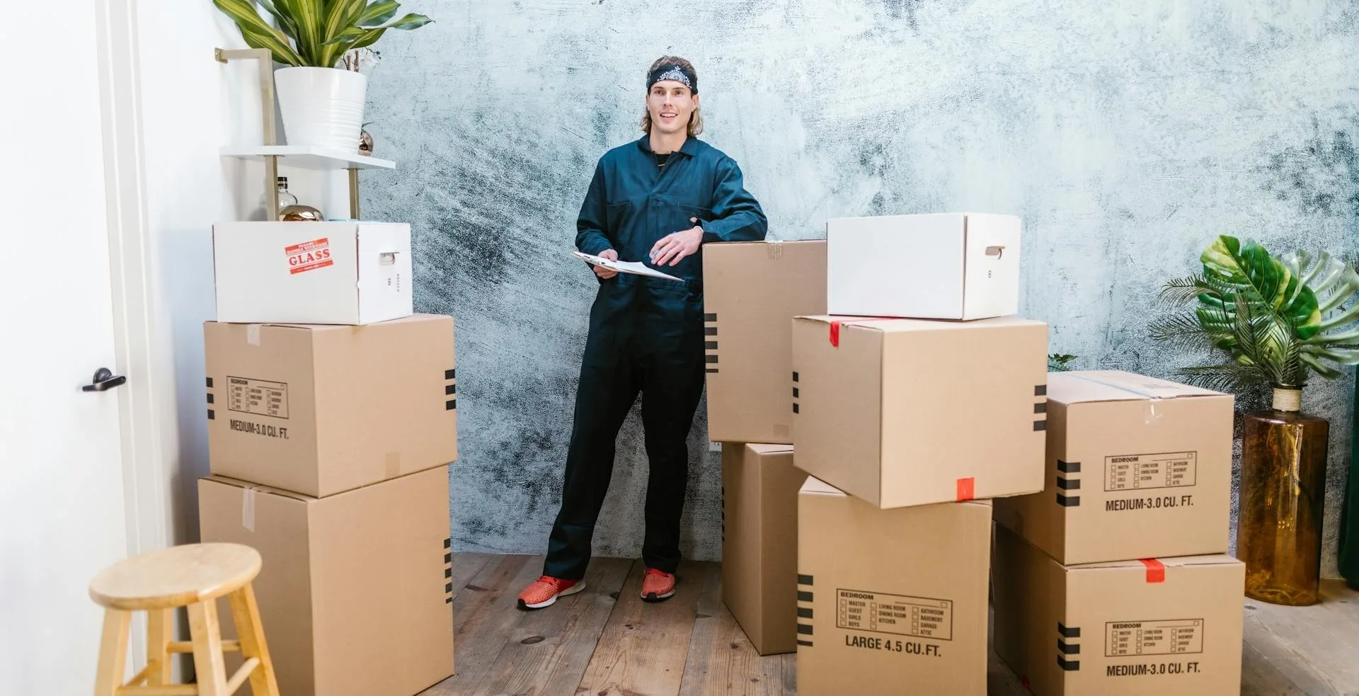 an experienced mover sitting infront of moving boxes