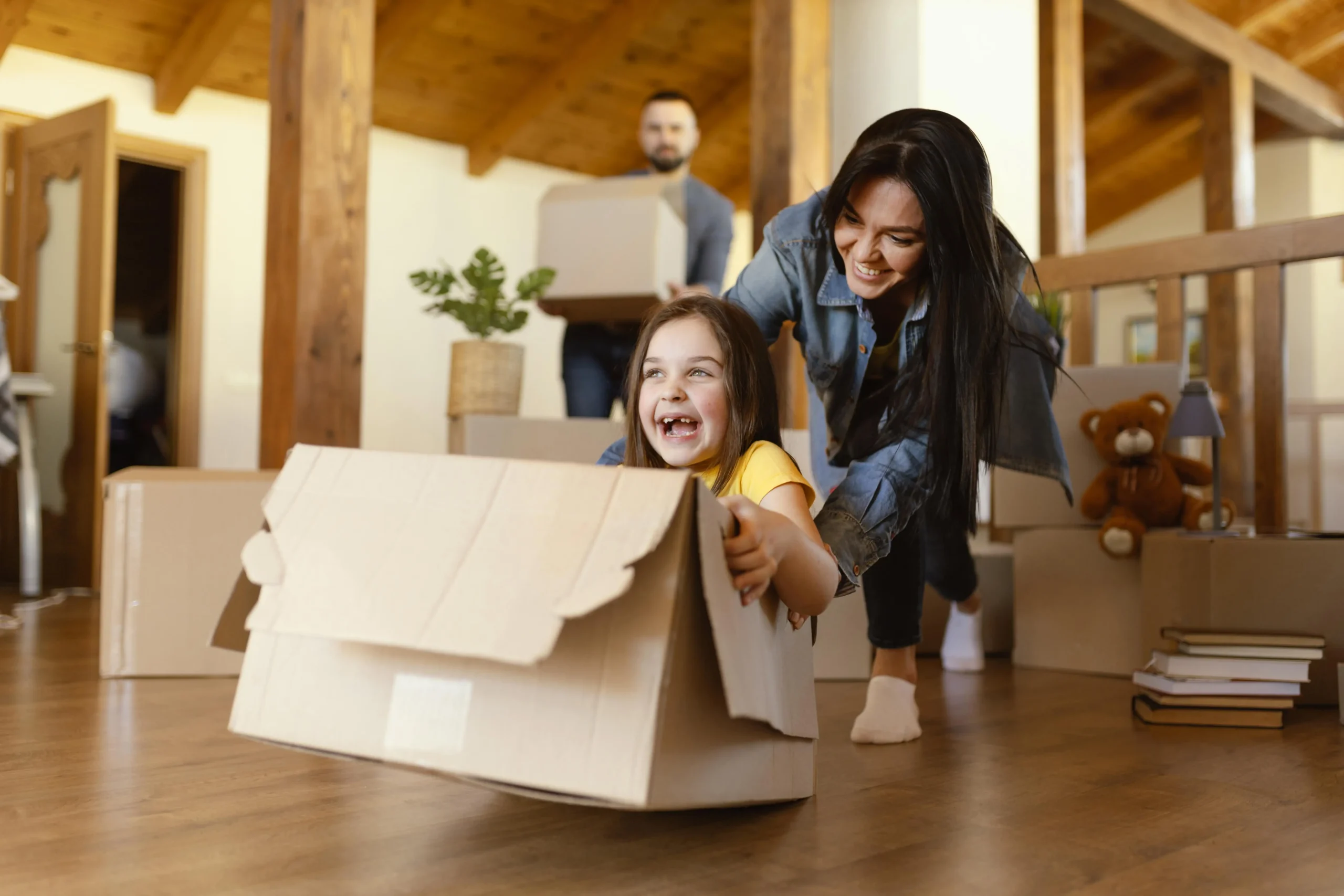 woman playing with happy kid while house shifting