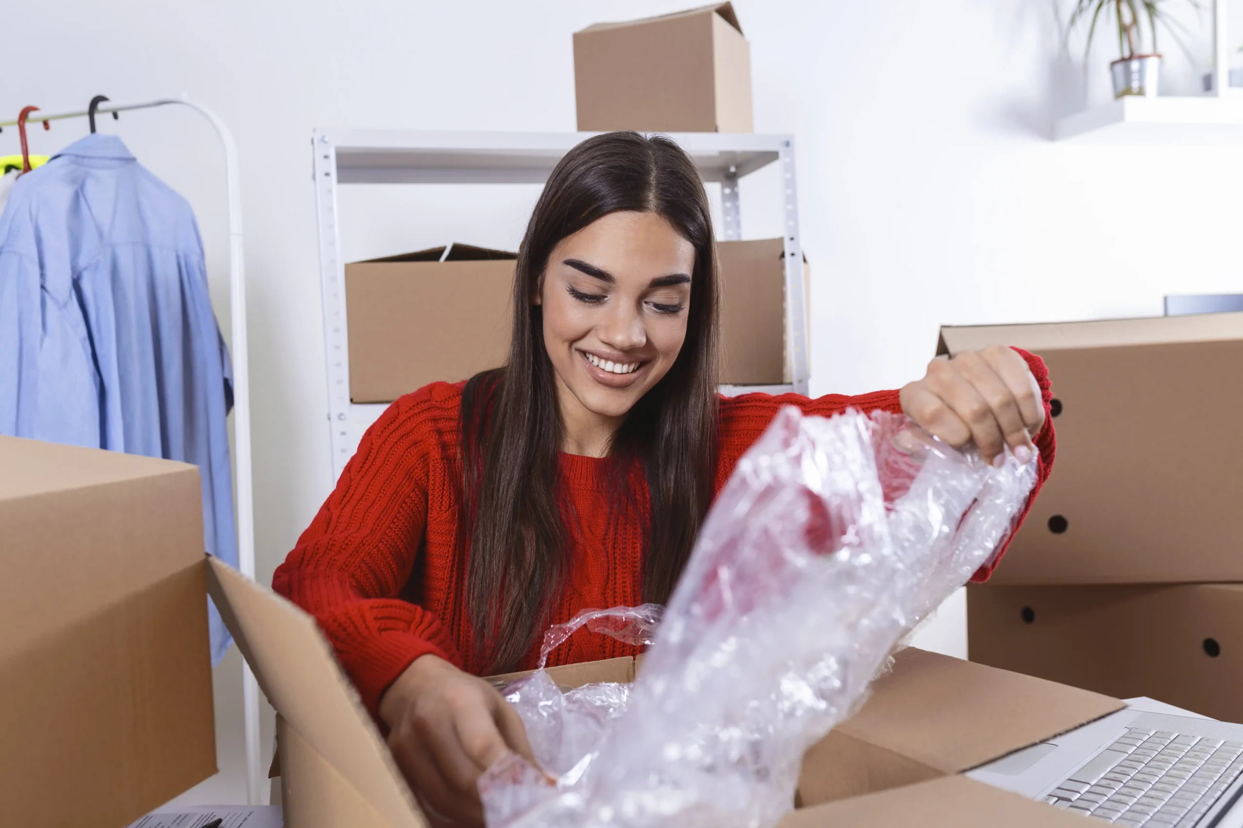 Young woman packing in box